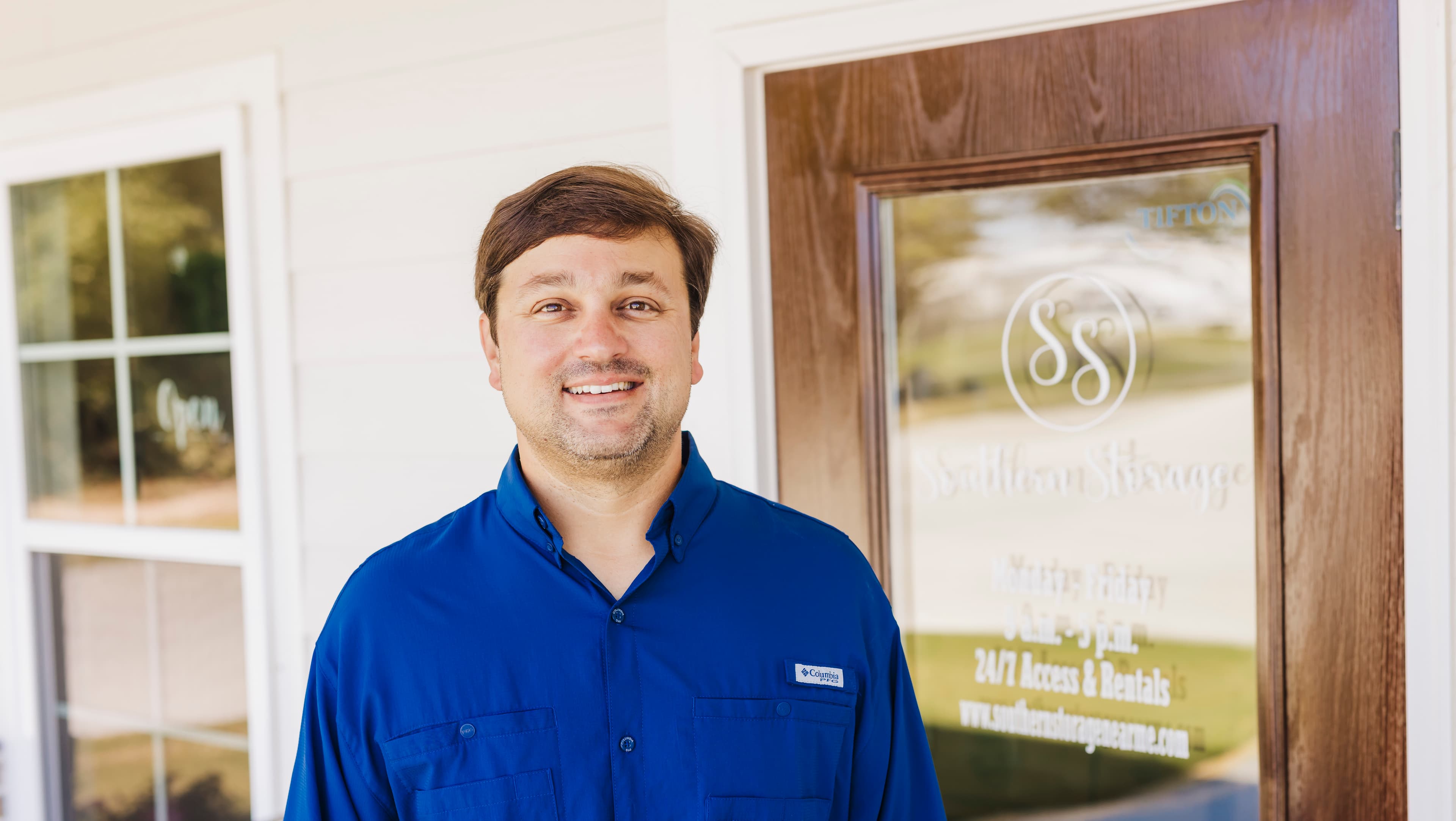 Smiling Southern Storage team member standing outside the office entrance